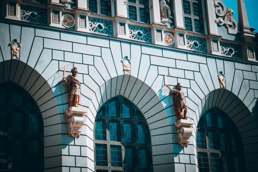 Intricate architectural facade with statues in Gdańsk, Poland, showcasing historic design elements.