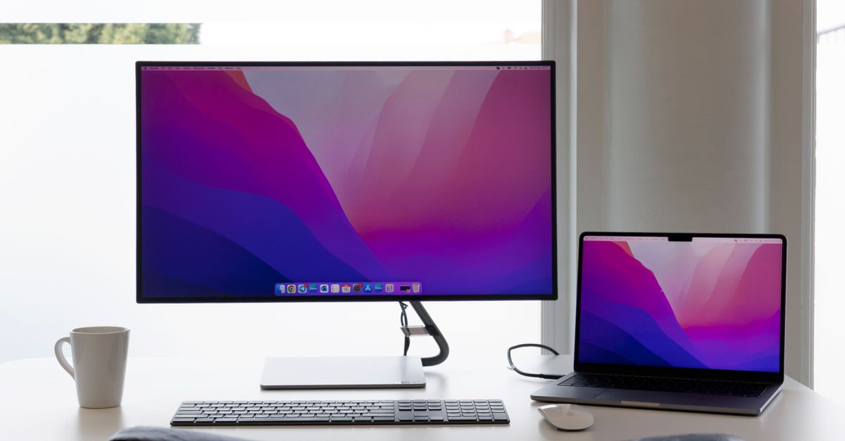 minimalist desk setup with single monitor and laptop
