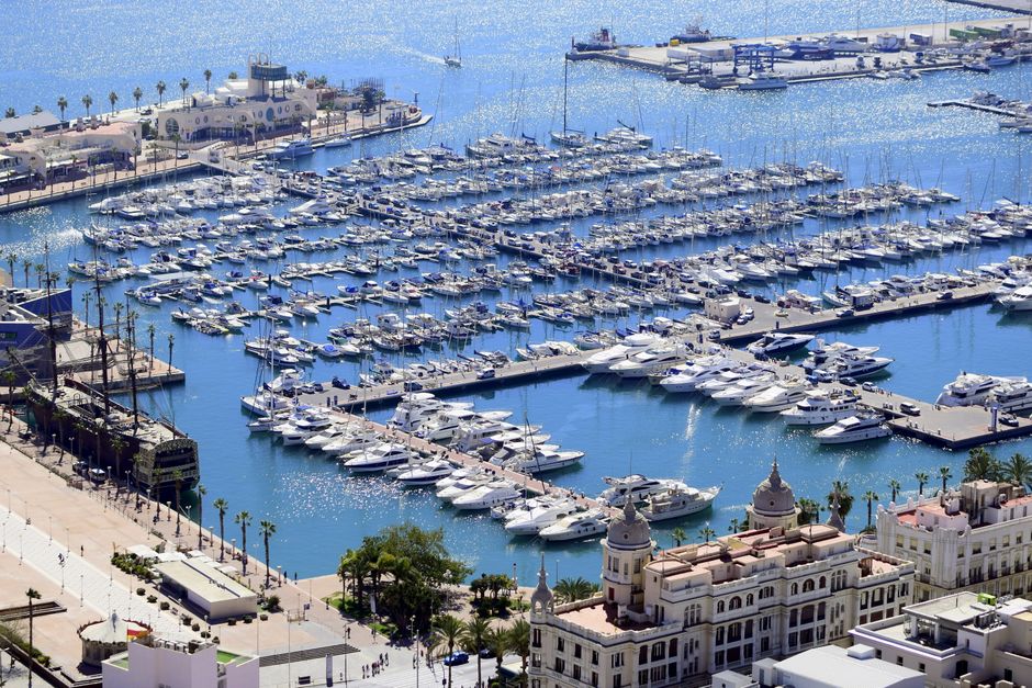 Breathtaking Unique 2 masts Classic Sailing Yacht in Barcelona Review: A Timeless Mediterranean Sailing Experience Review 2026 - Stunning aerial view of a bustling yacht harbor with buildings in a vibrant coastal city under a bright sunny sky.