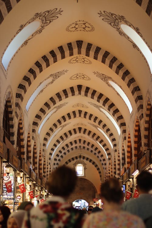 People Walking Under and Arched Ceiling 