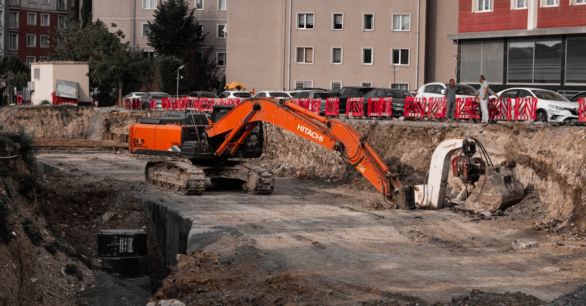 Photo by Alimurat Üral Excavators operating at an urban construction site, surrounded by residential buildings.