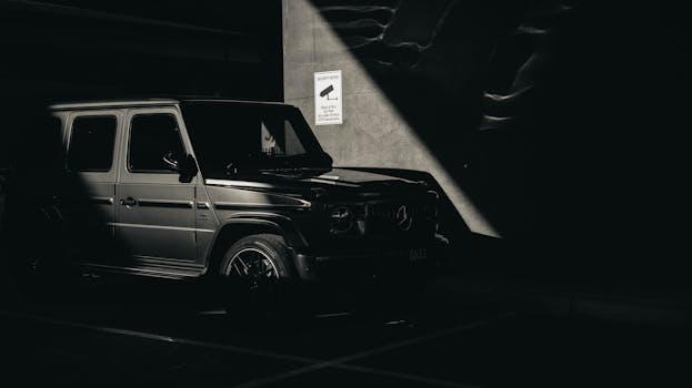 A Mercedes Benz SUV in a dramatic dark monochrome setting, parked indoors in Melbourne.
