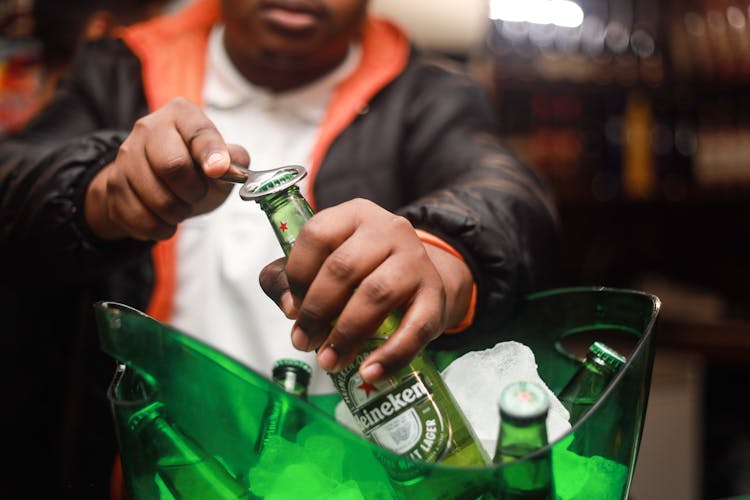 Man Opening A Bottle Of Beer