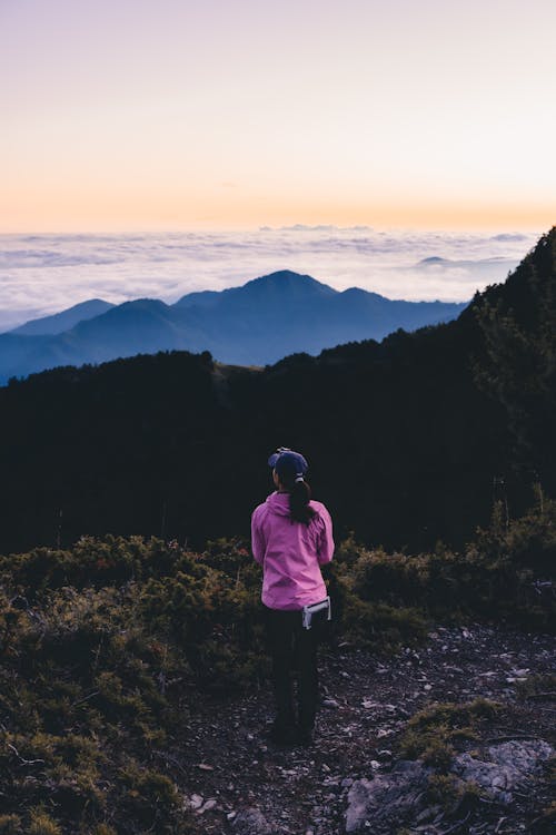 Woman in a Pink Jacket on Mountains