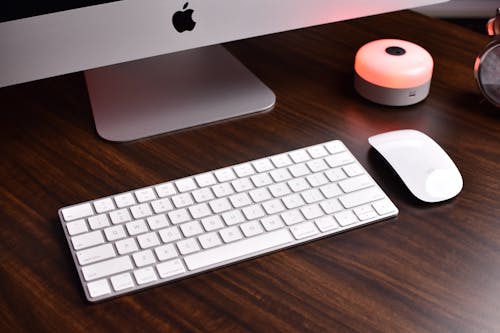 Wireless Computer Keyboard and Mouse on a Wooden Surface