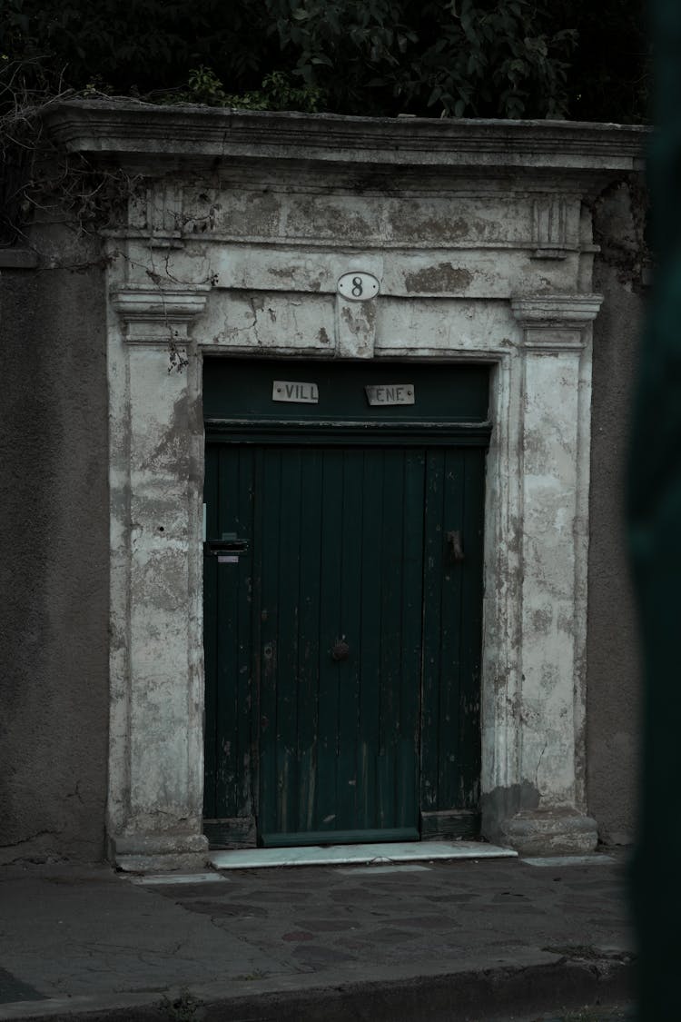 Green Wooden Door On Gray Concrete Wall