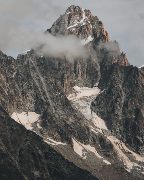 Free Breathtaking view of a rugged mountain peak in Chamonix, France enveloped in mist. Stock Photo