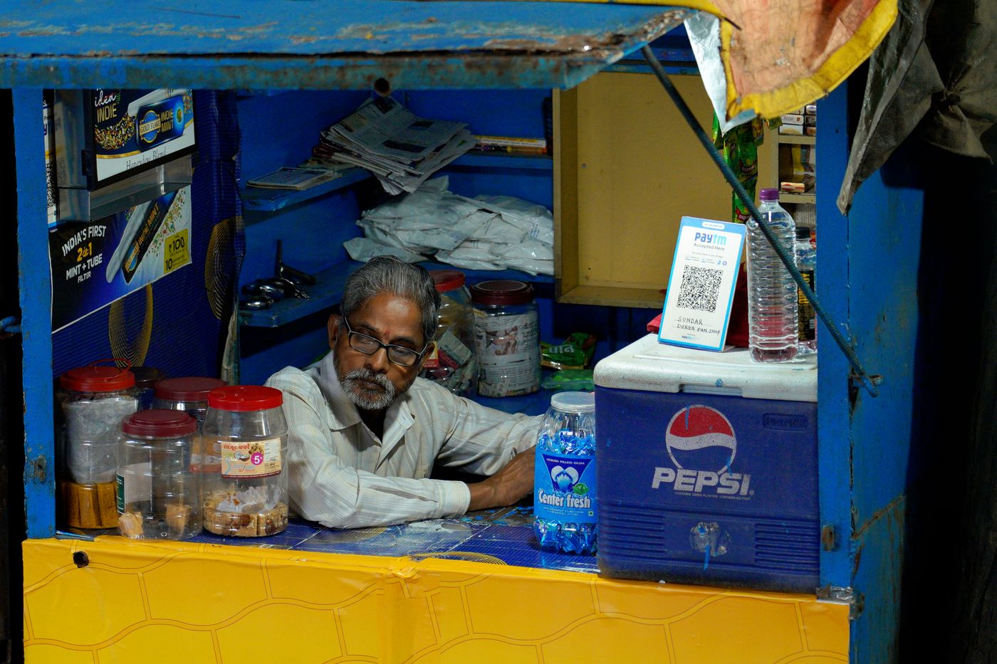 Indian merchant counter with Paytm and QR-based digital payment acceptance