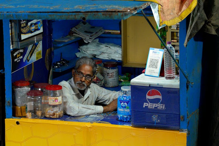 Man Sitting Inside A Store