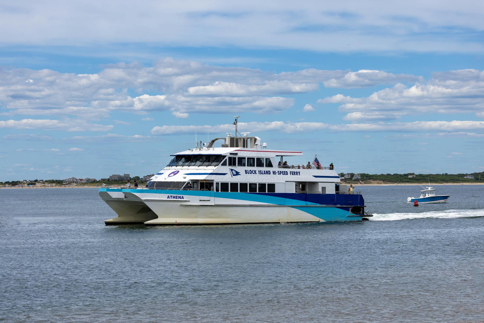 Athena ferry cruising in Newport, RI, offering scenic views. Ideal for travel and tourism imagery.