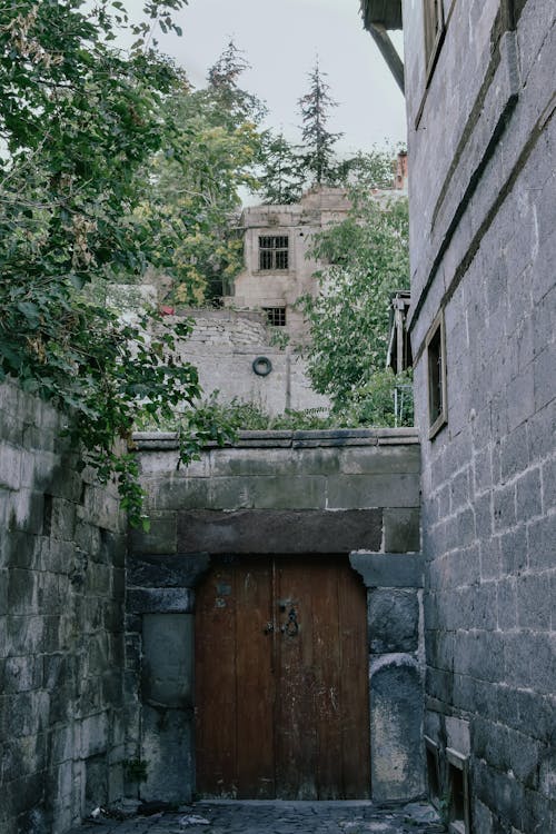 Brown Wooden Door on Gray Wall