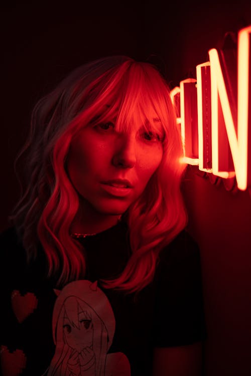 Woman Leaning on a Neon Light