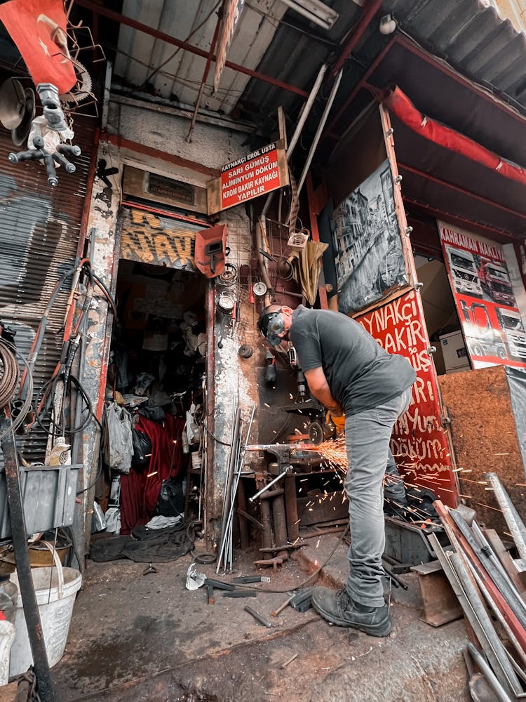 Man In A Workshop Using A Grinder 