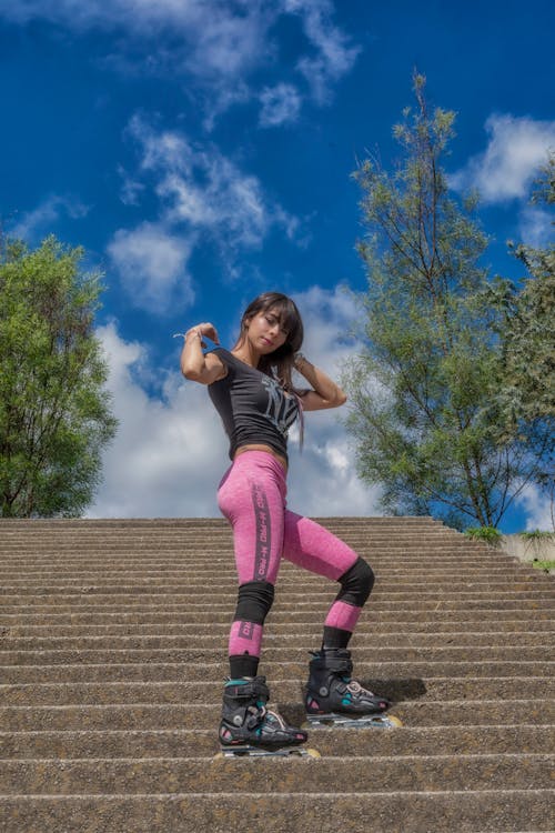 Woman Wearing Roller Skates Standing on Stairs