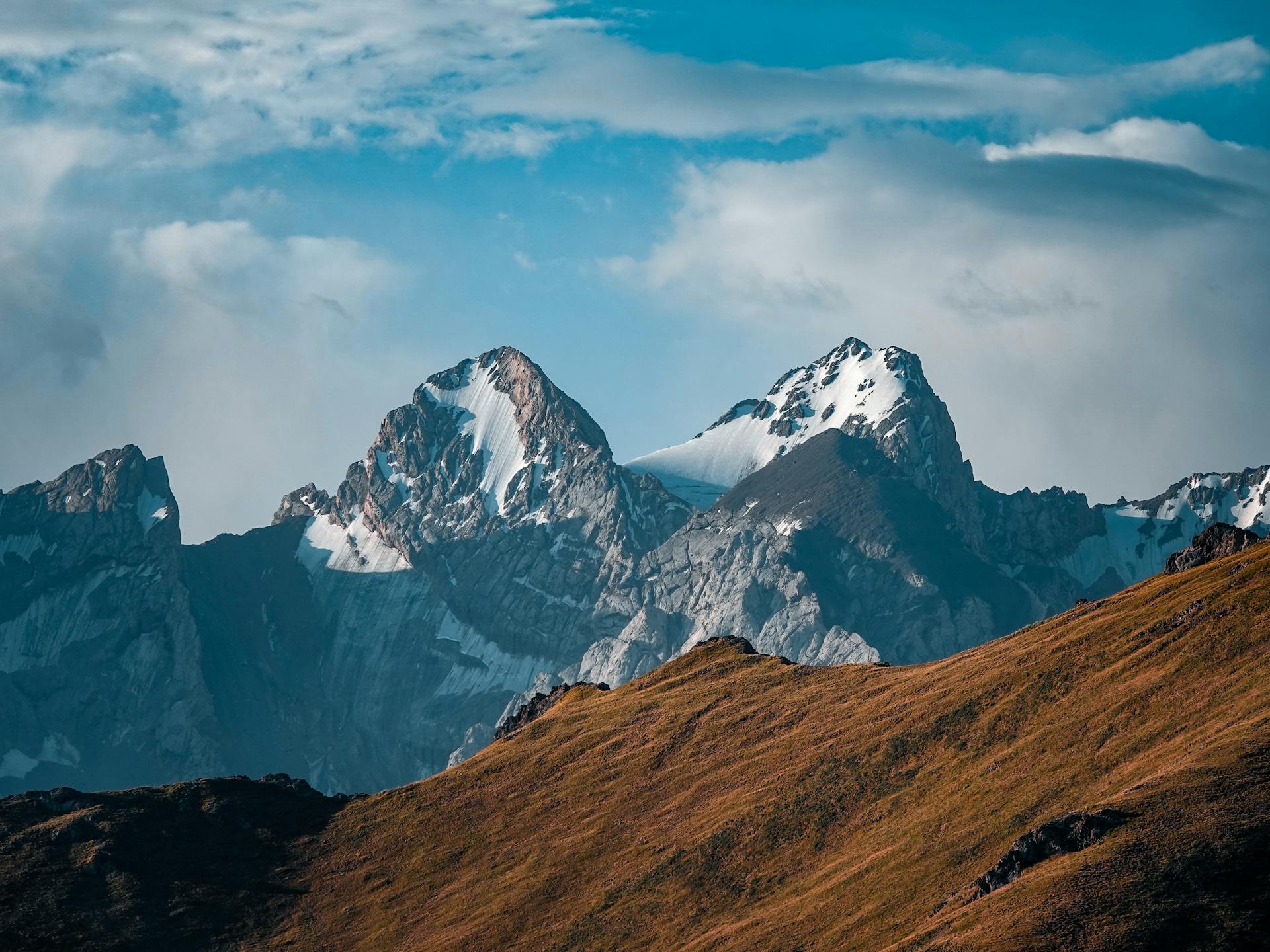 Majestic view of the snowcapped peaks in Ak-Sai, Kyrgyzstan, showcasing natural beauty and extreme terrain.