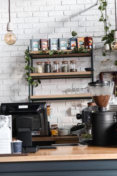 Inviting coffee shop counter featuring espresso machine and organized shelves.