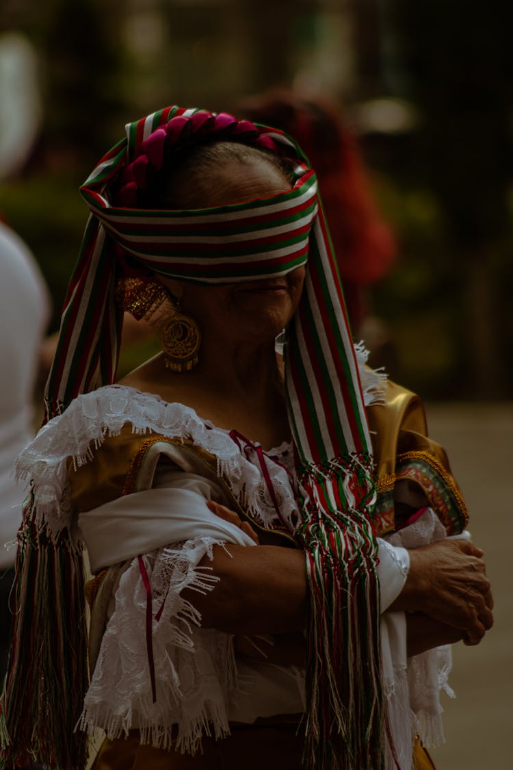 An Elderly Woman With Striped Blindfold 