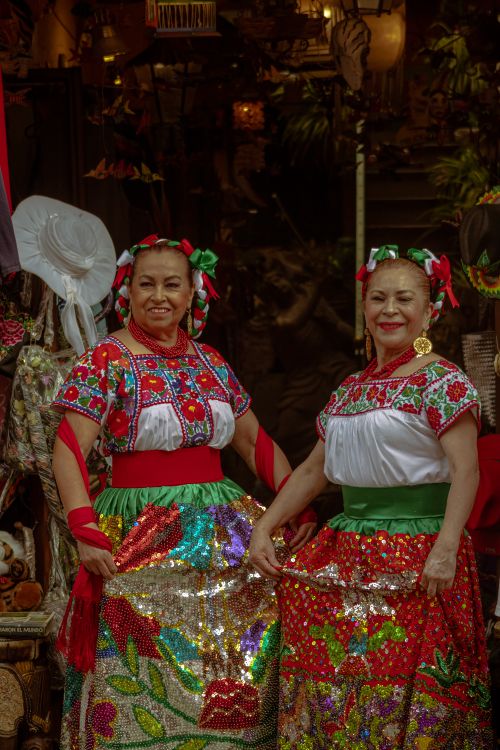 Free Women in vibrant Mexican dresses at festival in Puebla, celebrating cultural heritage. Stock Photo