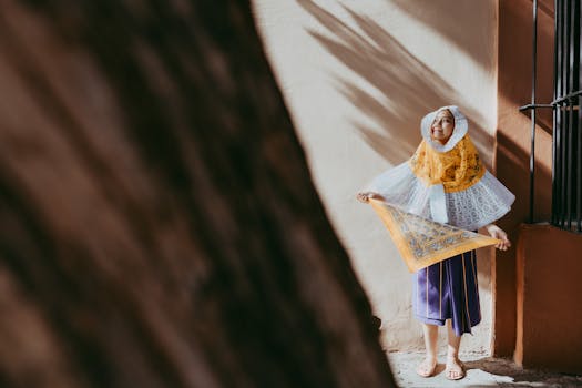 Captivating image of a woman in traditional Oaxaca attire holding a handkerchief, bathed in warm sunlight.