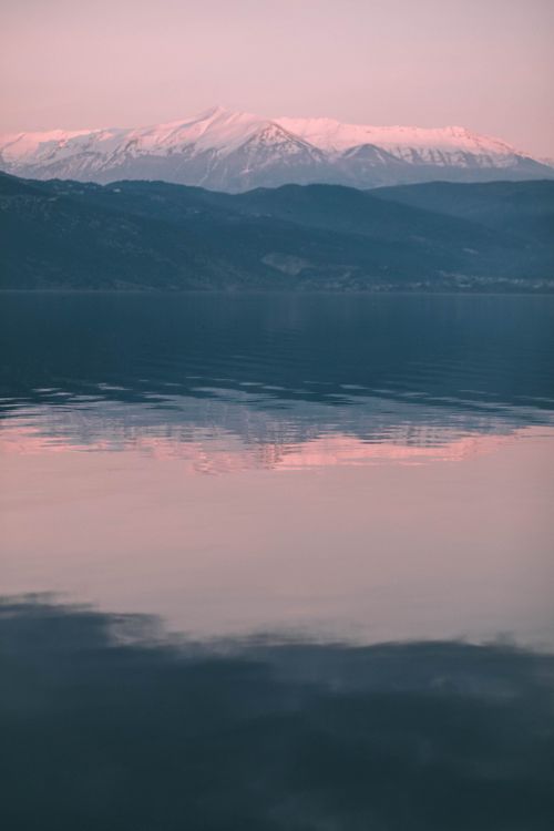Mountain reflected in a lake, photo by Maria Loznevaya on Pexels