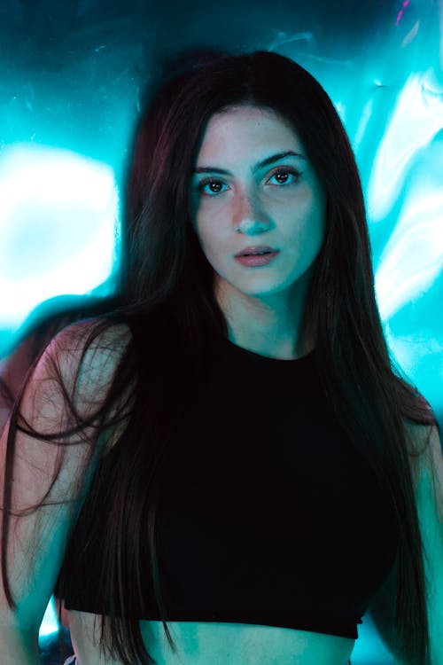Portrait of Brunette Posing in Blue Lights