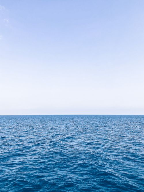 Free A serene view of the blue ocean meeting the horizon under a clear sky in Mersin, Turkey. Stock Photo