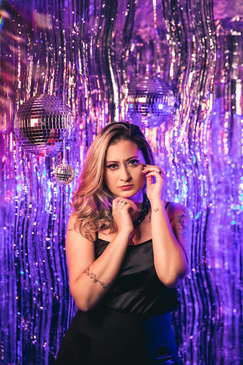 Woman in Black Tank Top Under Disco Balls