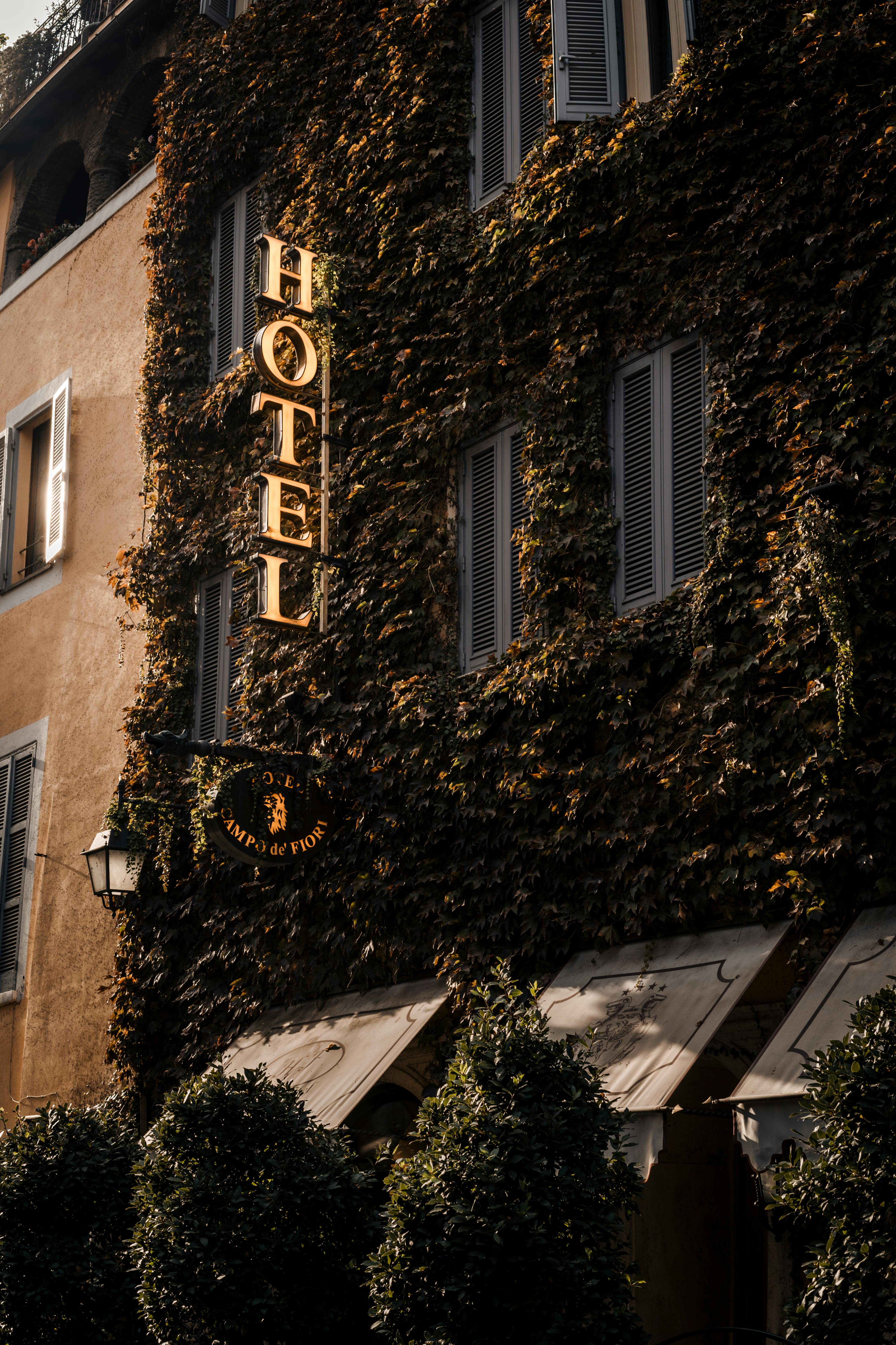 Ivy-covered hotel facade with classic windows and rustic charm in Campo de' Fiori.