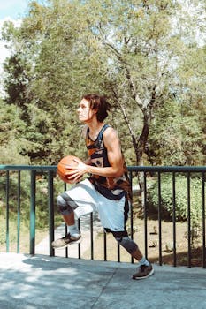 A young adult basketball player prepares to shoot outdoors in Mexico City, CDMX, Mexico.
