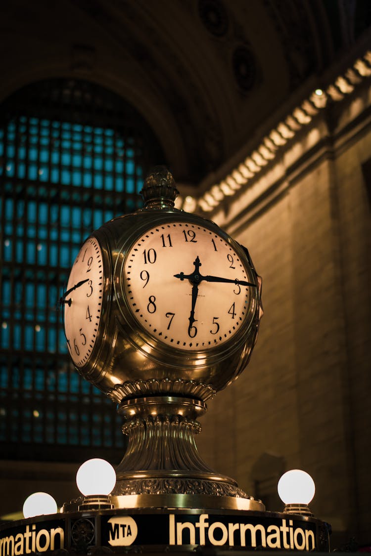 Clock At The Top Of An Information Booth