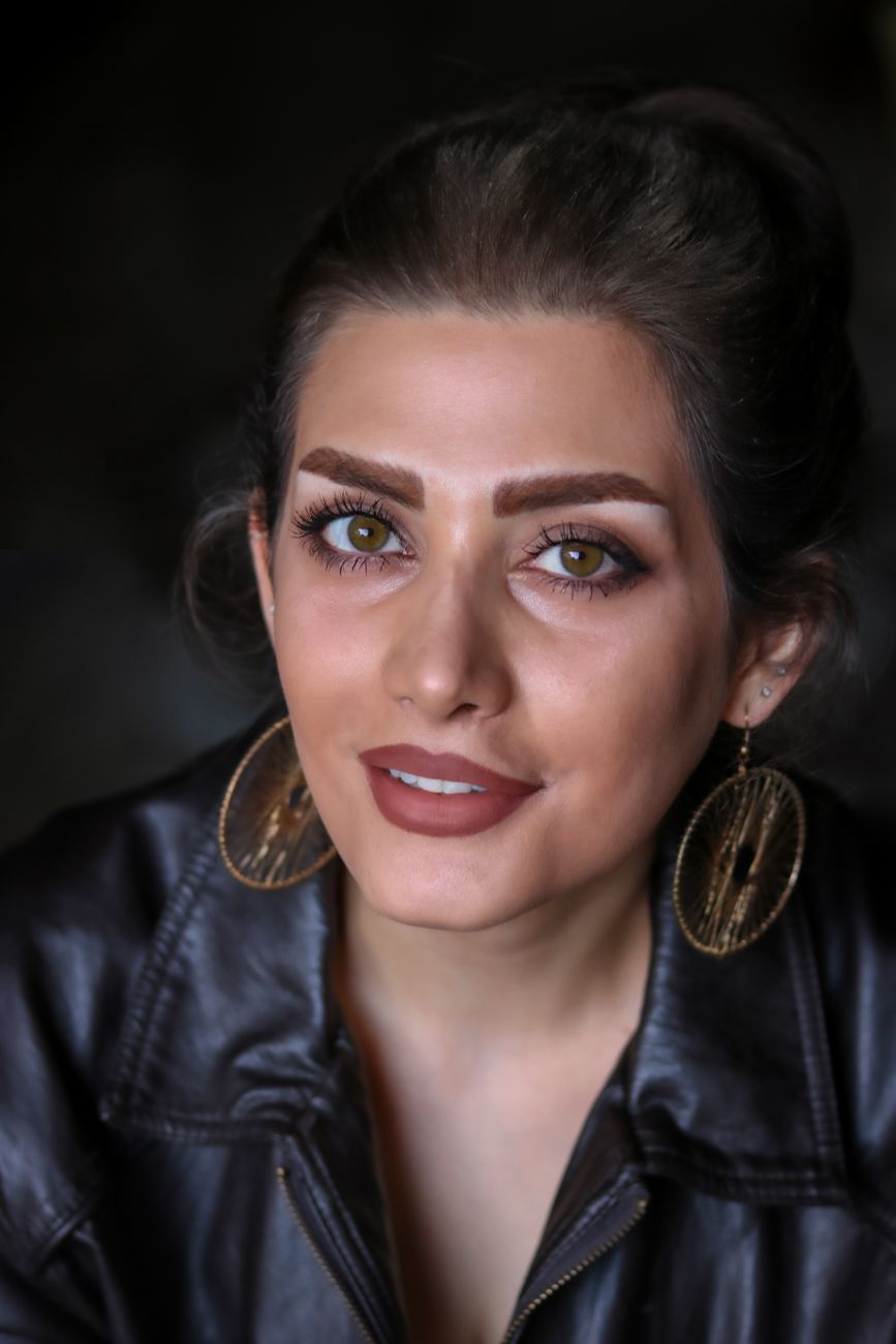 Stunning portrait of a woman with striking features and large earrings.
