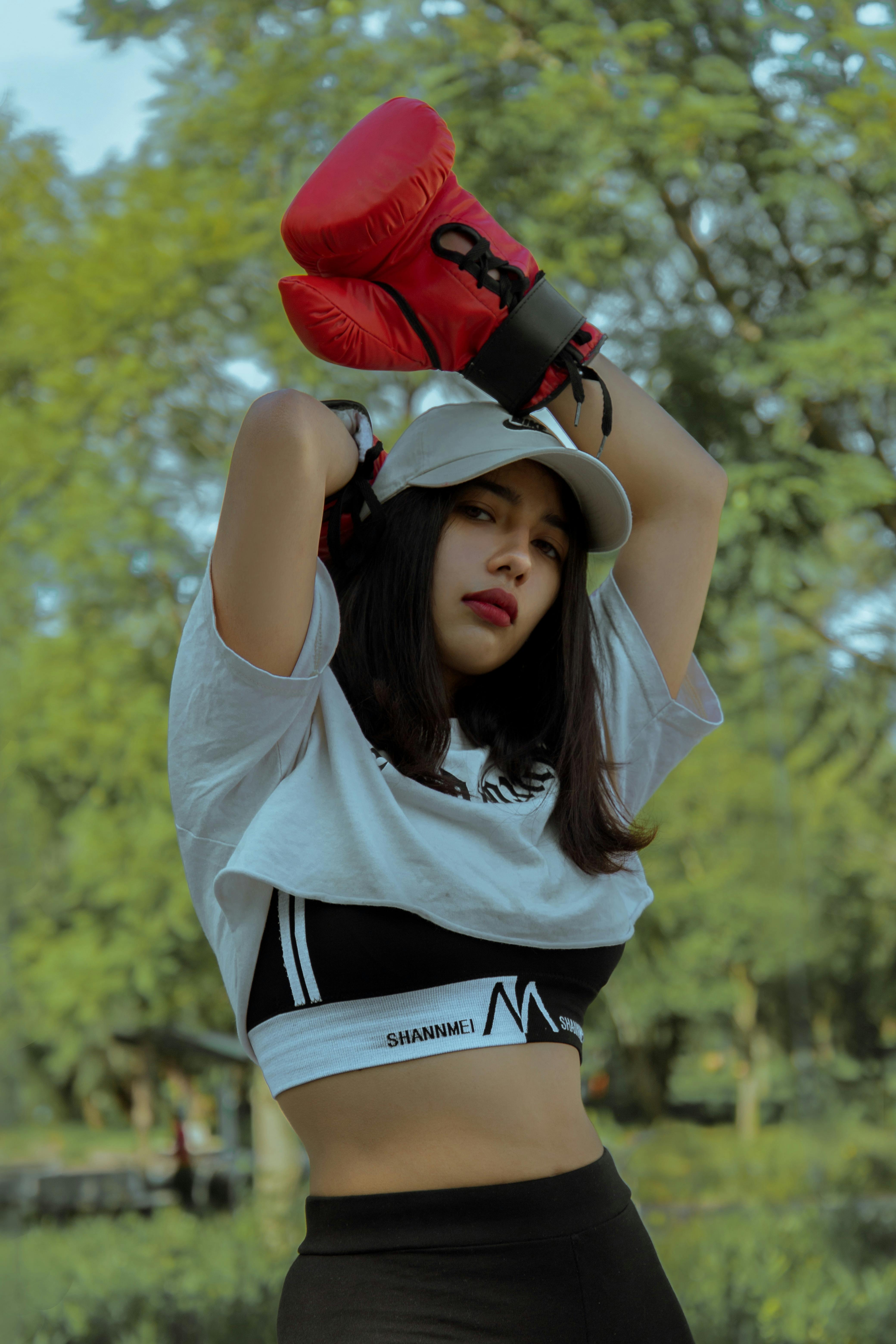 Woman Wearing a Crop Top and Red Boxing Gloves · Free Stock Photo