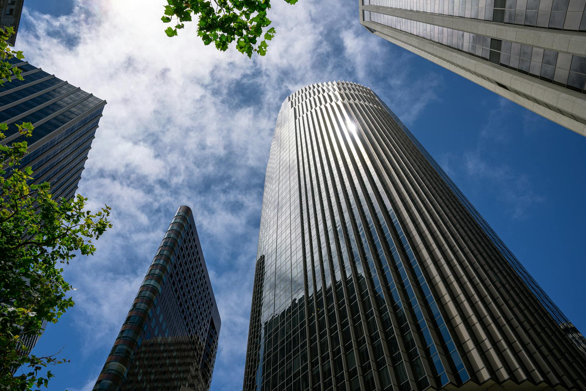 Low-angle view of skyscrapers in San Francisco under a vibrant blue sky