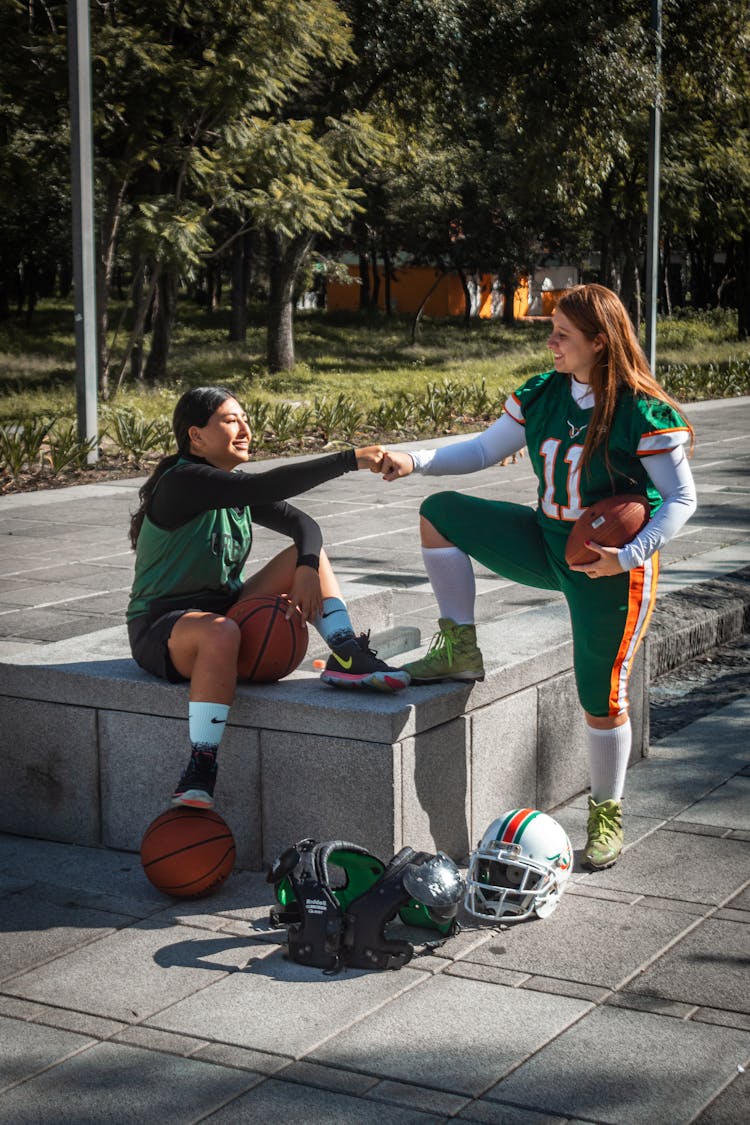 Women Engaged In Sports Bumping Fist