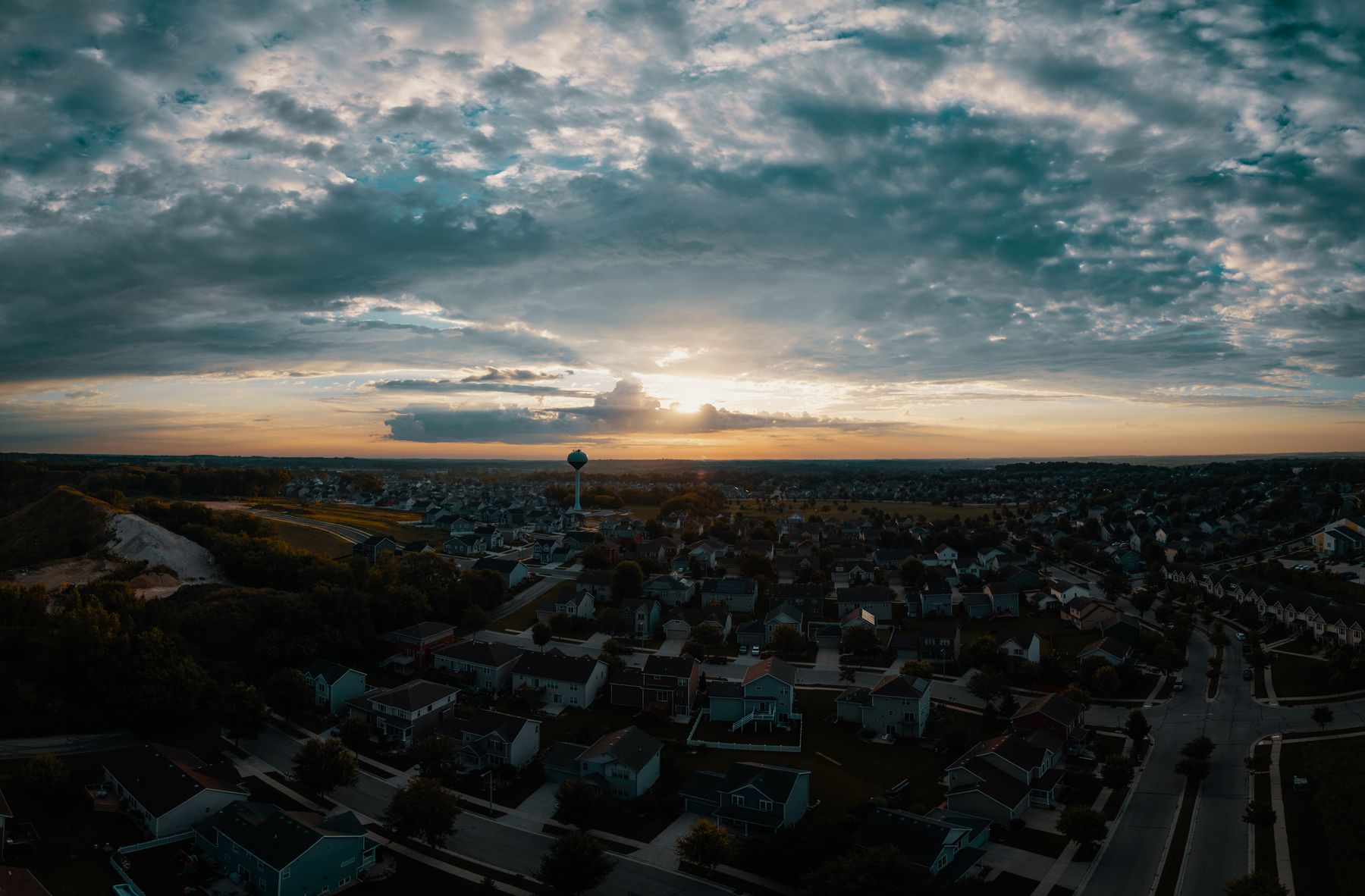 Aerial view of a suburb under a wide sunset sky, photo by Josh Sorenson on Pexels