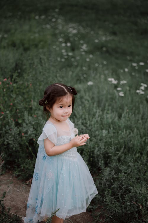 Cute Baby Girl in a Tulle Dress Outdoors 