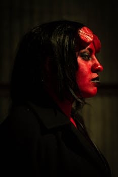 Dark and eerie portrait of a person in demon makeup, perfect for Halloween or horror themes.