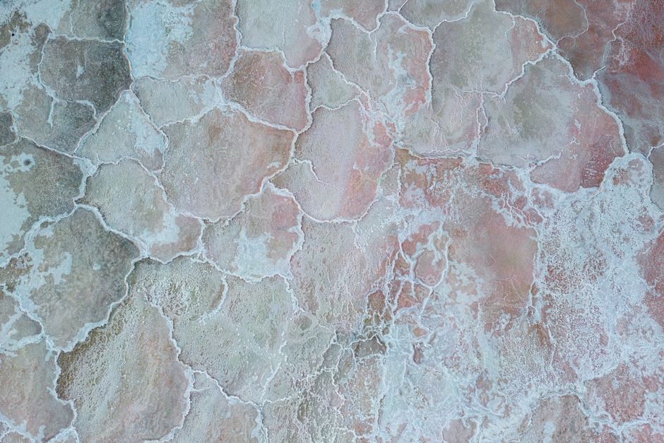 Aerial photo showcasing the unique patterns and colors of natural salt ponds.