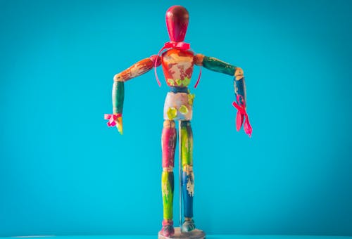 Free Selective Focus Photo of Multicolored Wooden Mannequin Stock Photo