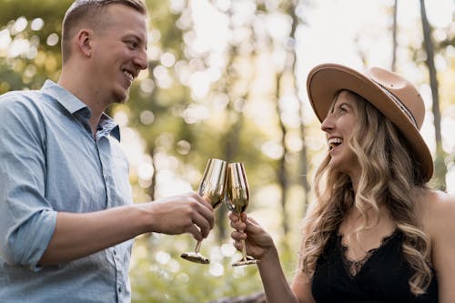 Man and Woman Smiling Holding Wine Glasses
