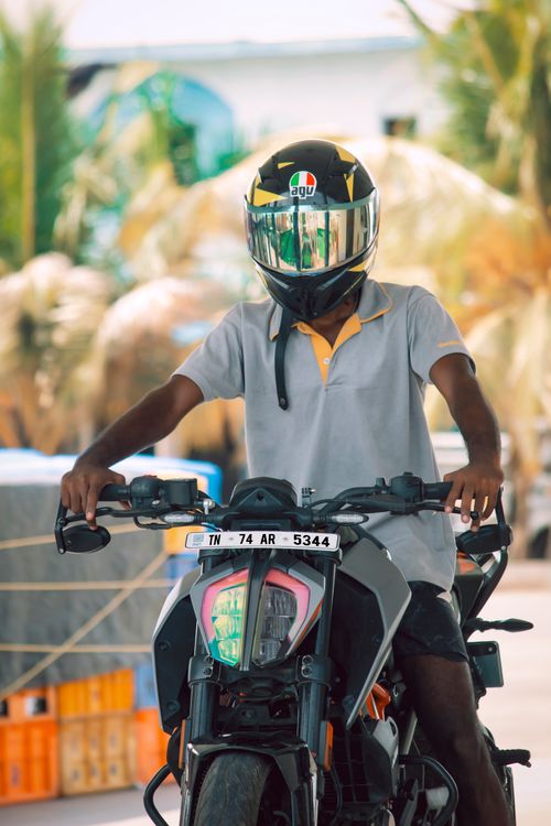 Free A motorcyclist wearing safety gear poses outdoors in Kanyakumari, India. Stock Photo