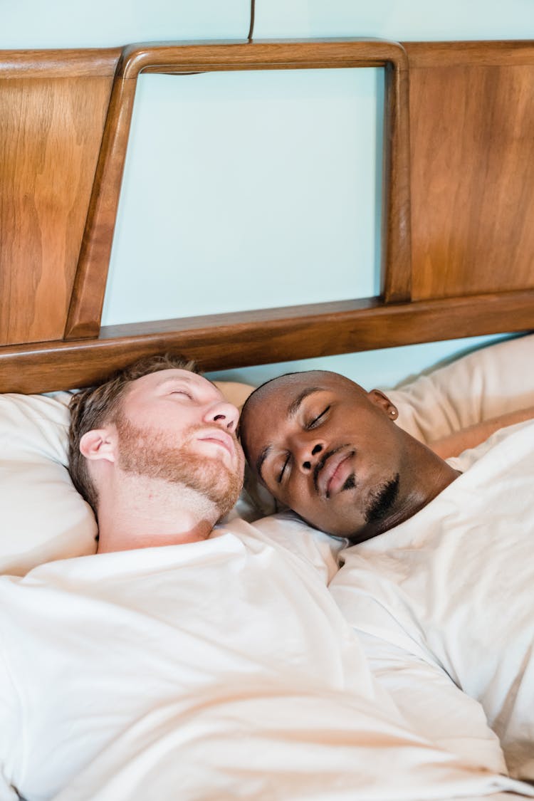 Gay Couple Sleeping In Bed Together 