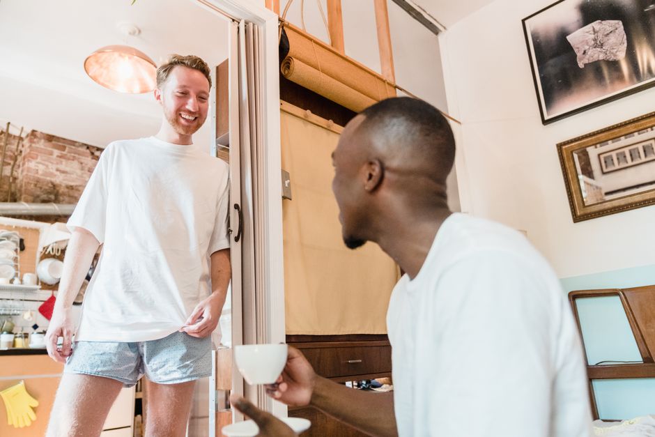 A happy couple enjoying a casual morning with coffee in their cozy living room.