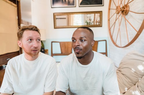 Portrait of a Gay Couple Sitting in Bedroom 