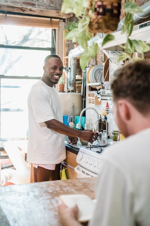 Men Talking and Cooking in a Kitchen