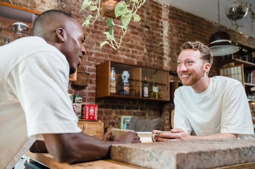 Smiling Men Having Coffee in a Kitchen 