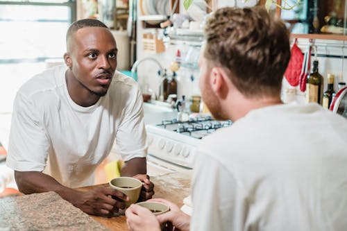 Free Male Couple Having Coffee in a Kitchen  Stock Photo