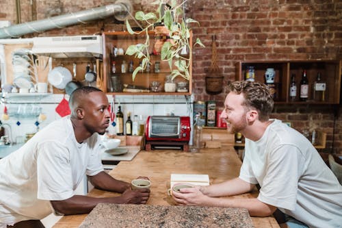 Free Men Looking at Each Other in a Kitchen  Stock Photo