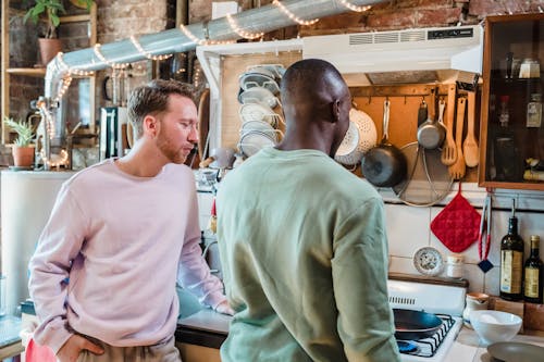 Men Standing by a Stove in a Kitchen 