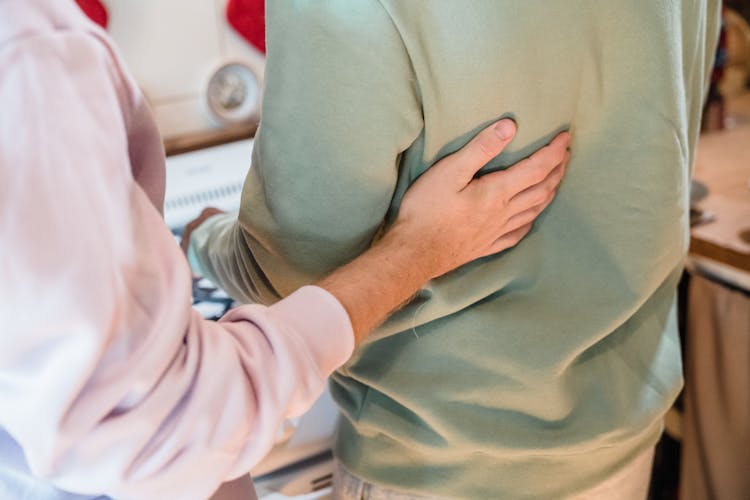 Man Putting Hand On Boyfriends Back 